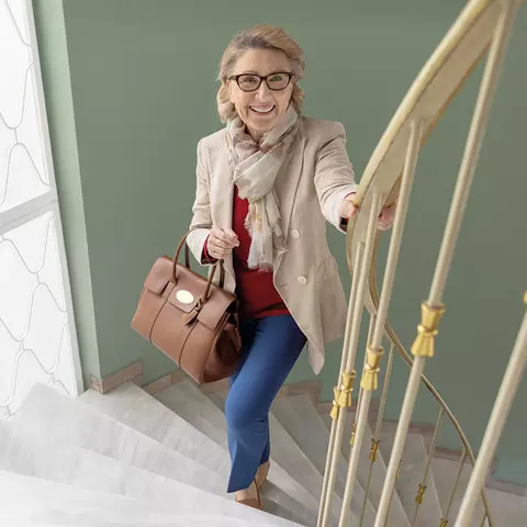 Dame steigt kraftvoll die Treppe hinauf